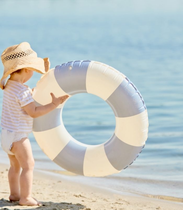 Toddler,In,Straw,Hat,With,Inflatable,Swim,Ring,Near,Water.